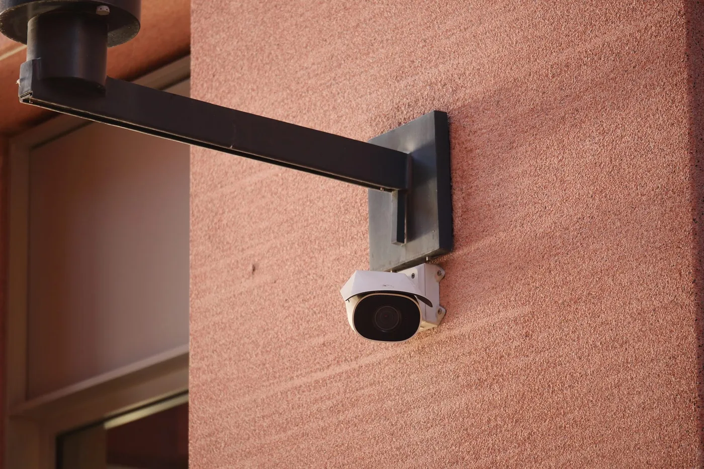 Exterior surveillance camera mounted on a commercial building wall
