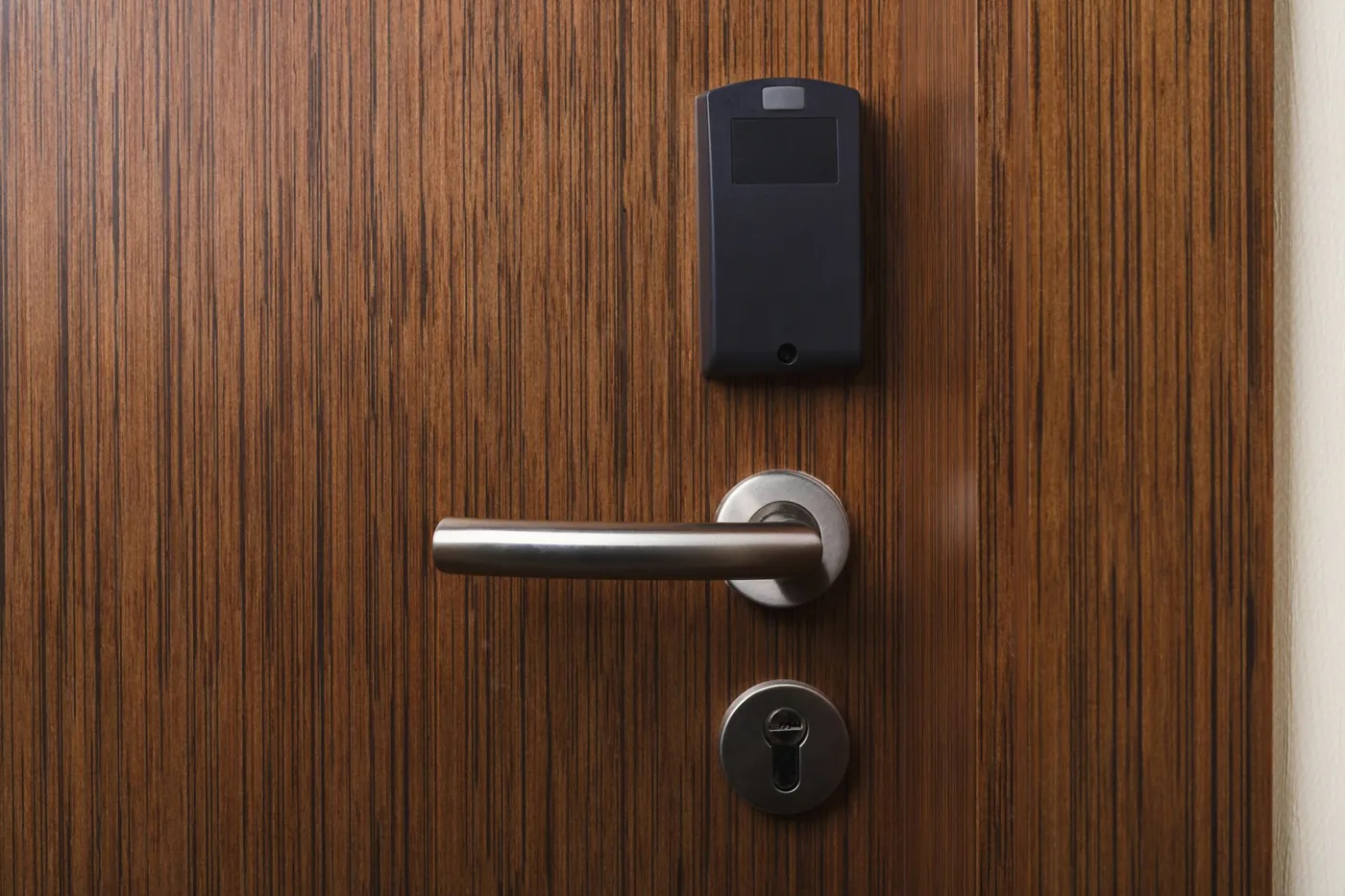 Electronic card-reader lock on a commercial entry door